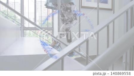 Climbing senior woman wearing patterned leggings and shoes on stair landing railings light artifact 140869558