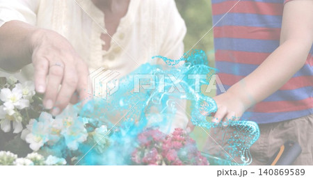 Working senior and boy in flower bed, cream top, striped tee, turquoise swirl, ringed hand, pruner Working senior and boy in flower bed, cream top, striped tee, turquoise swirl, ringed hand, pruner 140869589