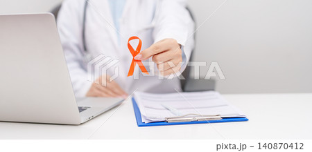 Doctor wearing lab coat giving orange ribbon for September Leukemia, March Kidney, August Appendix cancer, Multiple Sclerosis, Self Injury, November Complex Regional Pain Syndrome, CRPS and COPD Doctor wearing lab coat giving orange ribbon for September Leukemia, March Kidney, August Appendix cancer, Multiple Sclerosis, Self Injury, November Complex Regional Pain Syndrome, CRPS and COPD 140870412