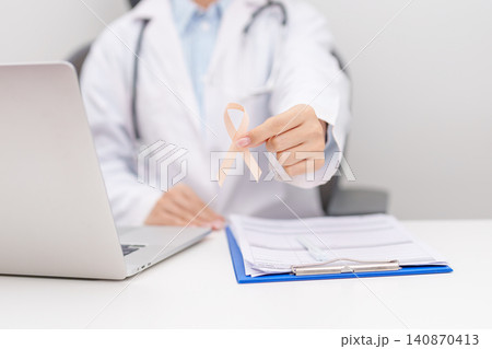 Doctor giving peach ribbon to patient for concept of September Uterine Cancer Awareness month, Endometrial Cancer, Gynecologic, Uterus and Ovaries, Endometriosis, June Vaginal cancer and World cancer 140870413