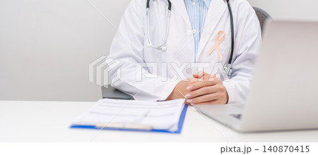 doctor using laptop and report notes on notebook. peach ribbon concept of September Uterine Cancer Awareness month, Endometrial, Gynecologic, Uterus and Ovaries, Endometriosis, June Vaginal cancer 140870415
