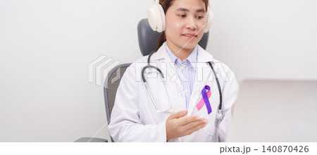 doctor using laptop for telehealth, online consultation and meeting about purple and pink ribbon concept of September Thyroid Cancer Awareness month, Healthcare and February world cancer day 140870426