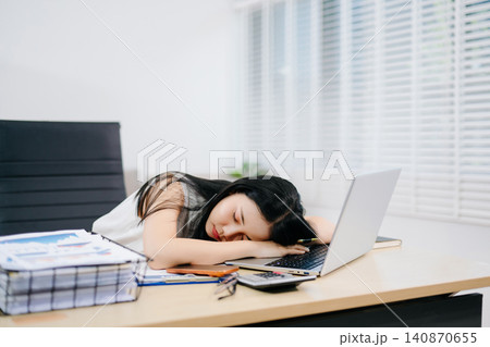 Stressed businesswoman working on laptop in a home office, facing workload, burnout and deadline pressure. Modern remote work, productivity and mental health concept. Stressed businesswoman working on laptop in a home office, facing workload, burnout and deadline pressure. Modern remote work, productivity and mental health concept. 140870655