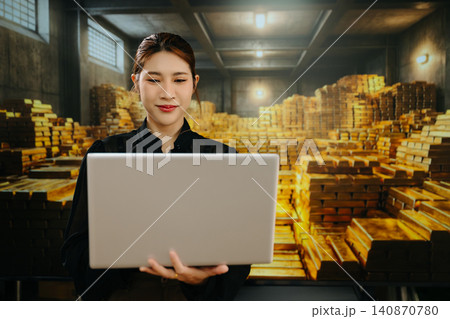 Business professional analyzing gold investment data on laptop inside gold vault, representing financial growth, commodity trading, wealth management and global market strategy. Business professional analyzing gold investment data on laptop inside gold vault, representing financial growth, commodity trading, wealth management and global market strategy. 140870780