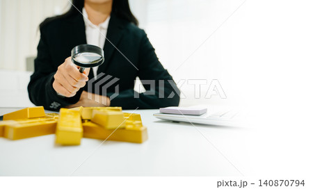 Business professional inspecting gold bars with magnifier. Investment, finance, security, risk analysis, fraud audit and wealth protection concept Business professional inspecting gold bars with magnifier. Investment, finance, security, risk analysis, fraud audit and wealth protection concept 140870794