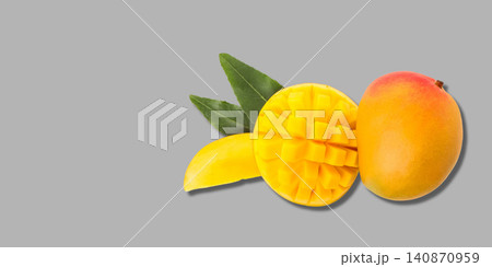 Ripe mango sits next to a sliced piece displaying rich yellow flesh. Sweet fruit concept Ripe mango sits next to a sliced piece displaying rich yellow flesh. Sweet fruit concept 140870959