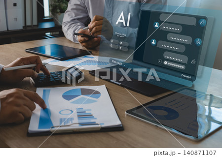 People use laptop AI chatbot interface with prompts, messages, charts, documents and calculator, applying data analytics automation for financial report review in office workspace. 140871107