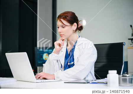 Professional female doctor reviewing patient information on a digital tablet in a modern clinic, showcasing healthcare technology, Professional female doctor reviewing patient information on a digital tablet in a modern clinic, showcasing healthcare technology, 140871540