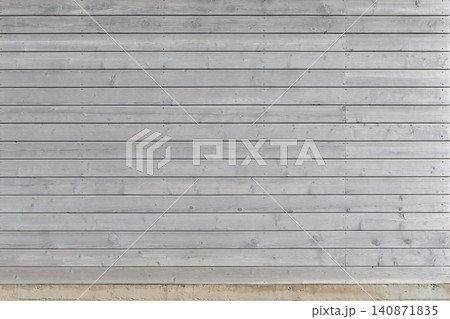 Gray painted wooden wall with weathered horizontal planks 140871835