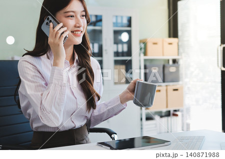 Young businesswoman professional employee using pc doing online banking analysing at workplace. Asian middle-aged business woman working on laptop computer in office, taking notes. Banner, copy space Young businesswoman professional employee using pc doing online banking analysing at workplace. Asian middle-aged business woman working on laptop computer in office, taking notes. Banner, copy space 140871988