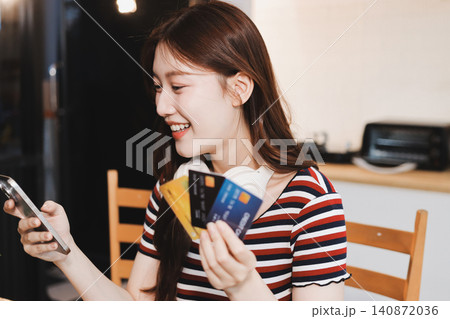 Happiness Entrepreneur beautiful business asian young woman wear casual use mobile phone for shopping online enjoy with social media and laptop at home.Small Business Startup.online banking Happiness Entrepreneur beautiful business asian young woman wear casual use mobile phone for shopping online enjoy with social media and laptop at home.Small Business Startup.online banking 140872036