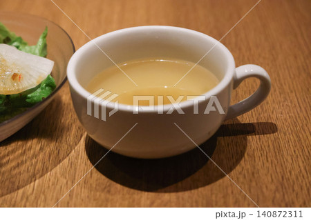 Clear broth soup in ceramic cup served with meal Clear broth soup in ceramic cup served with meal 140872311