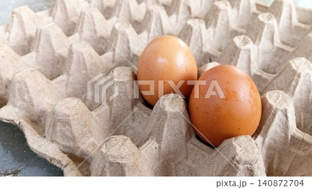 Close up of two fresh eggs in a tray. Close up of two fresh eggs in a tray. 140872704