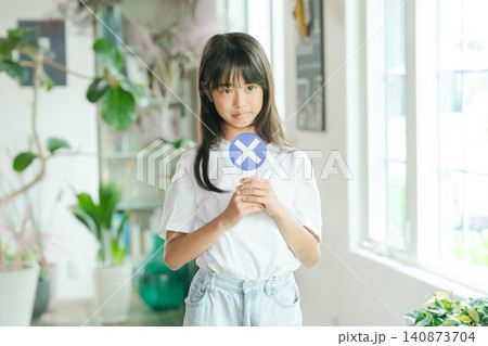 バツのプレートを持つ女の子 140873704