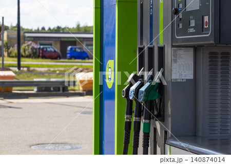 Fuel pump nozzle at a self service gas station Fuel pump nozzle at a self service gas station 140874014