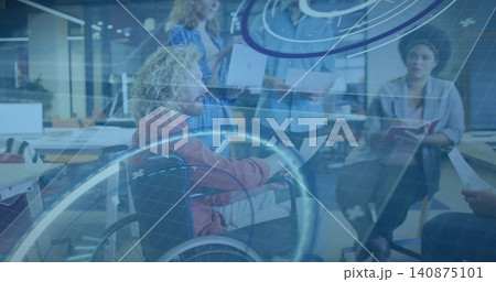 Leading man in wheelchair wearing rust jacket guiding team meeting at open office, with AR graphics Leading man in wheelchair wearing rust jacket guiding team meeting at open office, with AR graphics 140875101