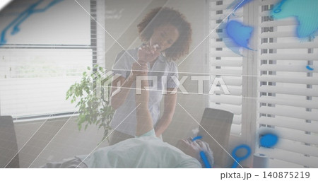 Checking female clinician in polo holding patient's wrist near face in clinic, with digital overlay Checking female clinician in polo holding patient's wrist near face in clinic, with digital overlay 140875219