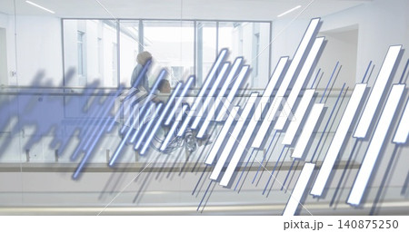 Pushing caregiver wearing coat guiding senior male in wheelchair through clinic hall, glass railing Pushing caregiver wearing coat guiding senior male in wheelchair through clinic hall, glass railing 140875250