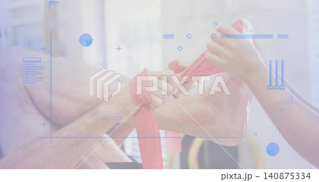 Stretching caregiver in short sleeves assisting senior's foot and ankle in rehab, with red band 140875334