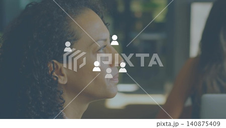 Facing mature woman in dark top viewing face avatars with laptop in workspace, copy space Facing mature woman in dark top viewing face avatars with laptop in workspace, copy space 140875409
