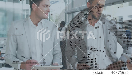 Holding clipboard, colleagues wearing light-gray blazers pointing at tablet through dotted glass Holding clipboard, colleagues wearing light-gray blazers pointing at tablet through dotted glass 140875630