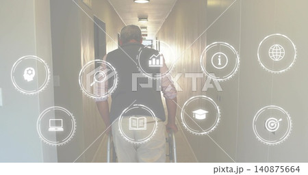 Walking senior pushing two-wheeled walker in care corridor, in dark vest, light pants with UI icons Walking senior pushing two-wheeled walker in care corridor, in dark vest, light pants with UI icons 140875664