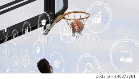 Reaching male in dark tank grabbing basketball caught in net at outdoor hoop with overlay icons 140875861