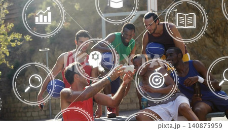 Taking selfie, six men at court holding phone and blue basketballs, wearing tanks, icons overlaying Taking selfie, six men at court holding phone and blue basketballs, wearing tanks, icons overlaying 140875959