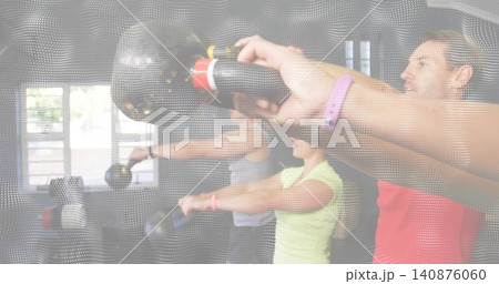 Lifting four members holding kettlebells and extending arms at studio windows, redshirt, overlay Lifting four members holding kettlebells and extending arms at studio windows, redshirt, overlay 140876060