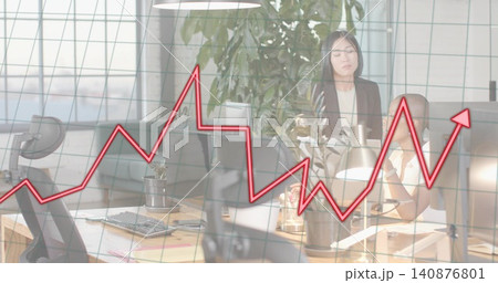 Presenting office team in business casual attire analyzing screens and laptop at desk, red overlay Presenting office team in business casual attire analyzing screens and laptop at desk, red overlay 140876801