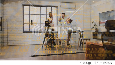 High-fiving team of four in businesswear in glass meeting room with laptops, data overlay High-fiving team of four in businesswear in glass meeting room with laptops, data overlay 140876805