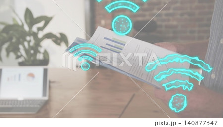 Holding printed report, hands in blue shirt reading charts at wooden desk with laptop AR icons Holding printed report, hands in blue shirt reading charts at wooden desk with laptop AR icons 140877347