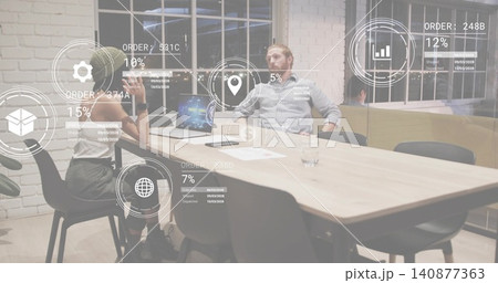 Discussing two coworkers in biz-casual reviewing laptop, papers on office table, and AR overlays Discussing two coworkers in biz-casual reviewing laptop, papers on office table, and AR overlays 140877363