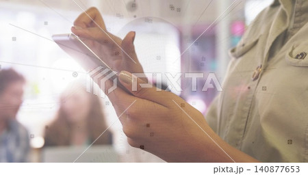 Holding smartphone, adult woman tapping screen during office meeting, wearing button shirt 140877653