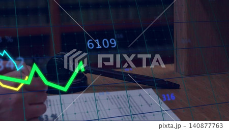 Resting wooden gavel and ballpoint pen on office tabletop, showing printed data and chart overlays Resting wooden gavel and ballpoint pen on office tabletop, showing printed data and chart overlays 140877763