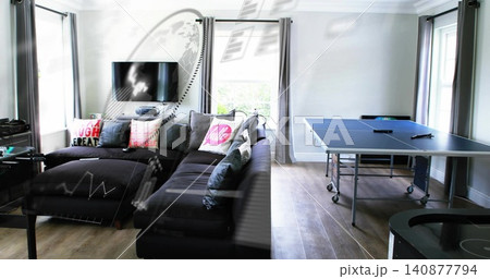 Showing dark gray L-shaped sectional chaise left in living room, featuring blue ping pong table 140877794