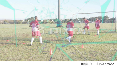 Dribbling four players in red jerseys training near goal on pitch with ball, cones, teal overlay Dribbling four players in red jerseys training near goal on pitch with ball, cones, teal overlay 140877922