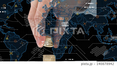Pinching adult hand placing small stack of golden coins on white surface, with digital map overlay Pinching adult hand placing small stack of golden coins on white surface, with digital map overlay 140878942