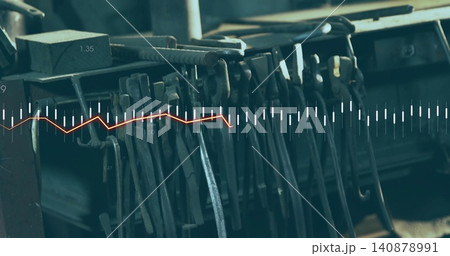 Hanging metal tools forming dense array on workshop rack, with block, coiled rod and data overlay 140878991