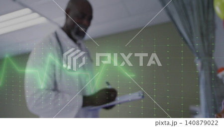 Writing mature doctor in white lab coat taking notes in exam room, with stethoscope and clipboard 140879022
