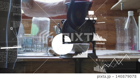 Turning man's forearm with rolled sleeve operating castiron grinder at kitchen counter, HUD overlay 140879078