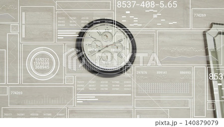 Showing dark-rimmed analog clock with subdials on wooden desk with HUD overlays and partial device Showing dark-rimmed analog clock with subdials on wooden desk with HUD overlays and partial device 140879079