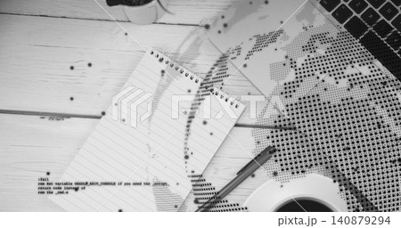 Showing spiral notepad resting diagonal on wood desk with pen, keyboard, coffee, halftone map, code 140879294