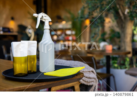 Cleaning spray bottle and napkins on tray at restaurant Cleaning spray bottle and napkins on tray at restaurant 140879861