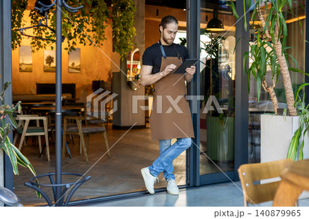 Small business owner checking data on tablet Small business owner checking data on tablet 140879965