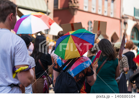 Participant carrying rainbow umbrella during Pride 140880104