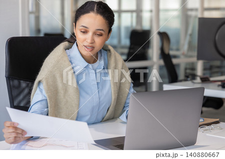 Businesswoman reviewing financial charts 140880667