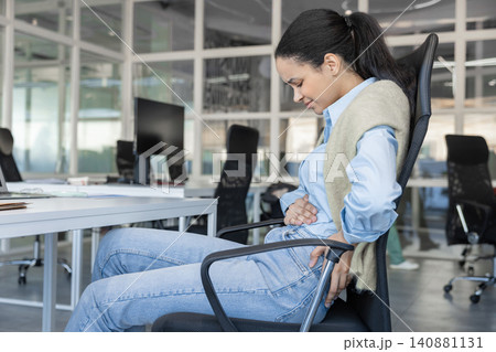 Woman suffering from stomach ache and back pain Woman suffering from stomach ache and back pain 140881131