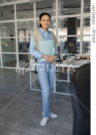 Full length portrait of young businesswoman in office Full length portrait of young businesswoman in office 140881297