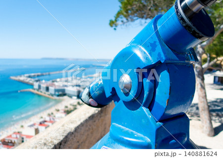 Tourist Viewing Telescope Overlooking Harbor and Sea 140881624